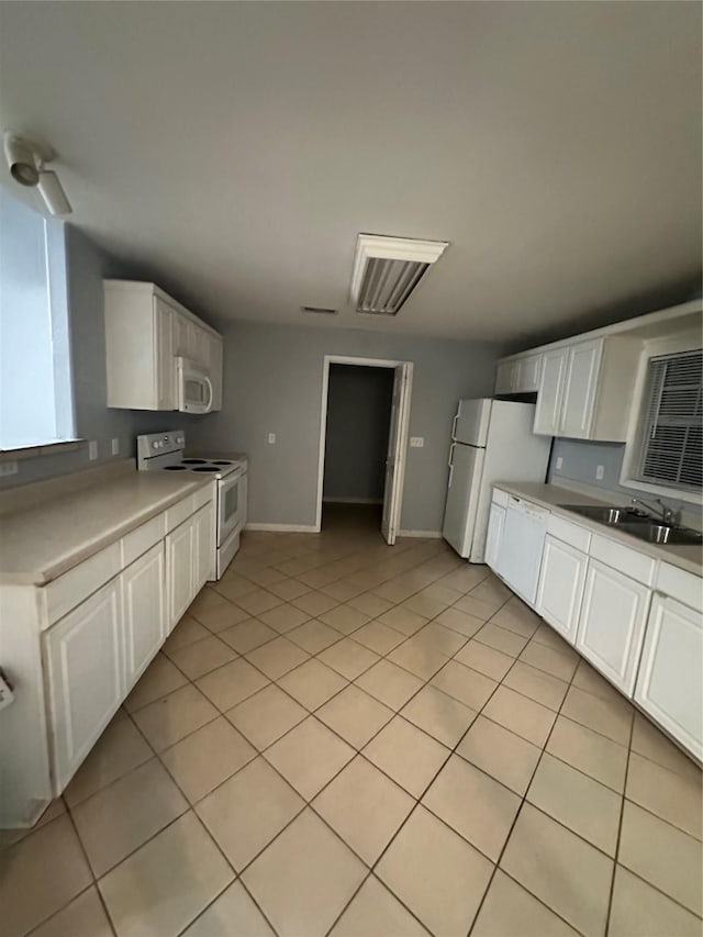 227 S Brownell St, La Porte, TX 77571 - kitchen with white appliances, a sink, white cabinetry, light countertops, and light tile patterned floors