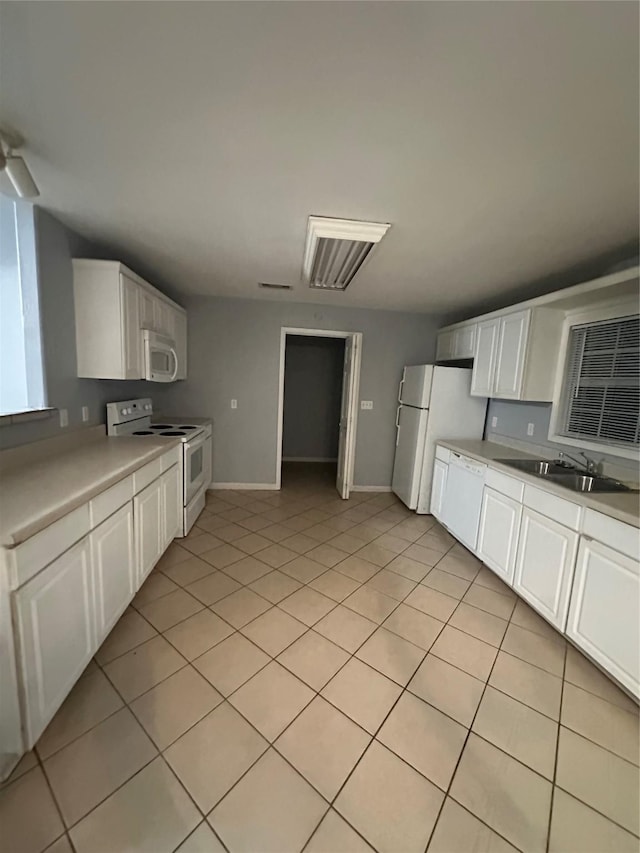 227 S Brownell St, La Porte, TX 77571 - kitchen with white appliances, a sink, and white cabinets
