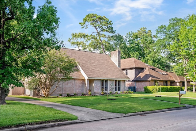 3707 Brook Shadow Dr, Houston, TX 77345 - view of front of home featuring a front yard, a chimney, and brick siding
