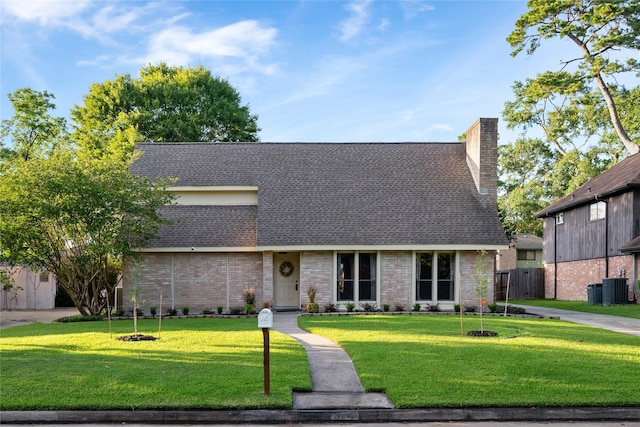3707 Brook Shadow Dr, Houston, TX 77345 - mid-century modern home with central AC unit, brick siding, a chimney, and roof with shingles