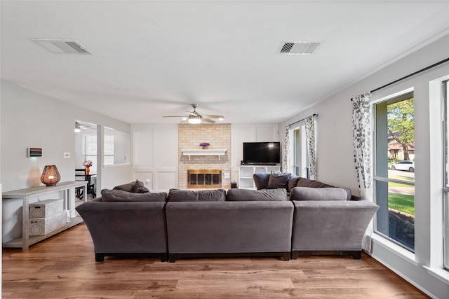 3707 Brook Shadow Dr, Houston, TX 77345 - living area featuring ceiling fan, light wood-style flooring, and a brick fireplace