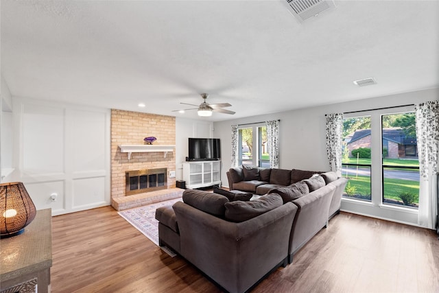 3707 Brook Shadow Dr, Houston, TX 77345 - living area with ceiling fan, wood finished floors, and a brick fireplace