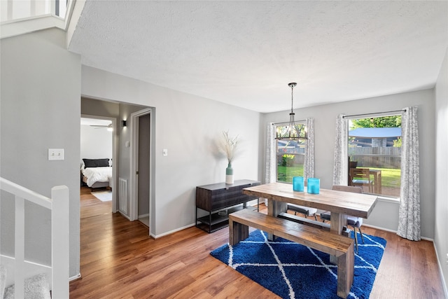 3707 Brook Shadow Dr, Houston, TX 77345 - dining room with light wood-type flooring, a textured ceiling, and baseboards