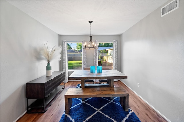 3707 Brook Shadow Dr, Houston, TX 77345 - dining area featuring a chandelier, wood finished floors, and baseboards