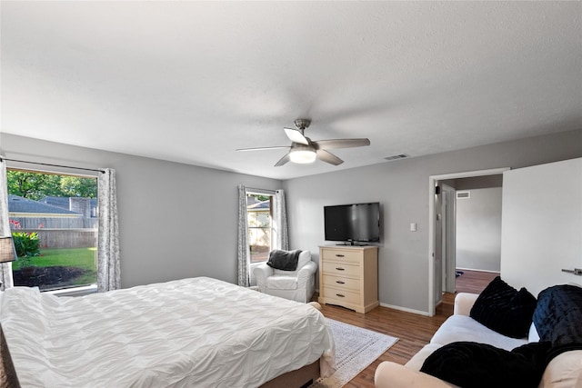 3707 Brook Shadow Dr, Houston, TX 77345 - bedroom with wood finished floors, a ceiling fan, and baseboards