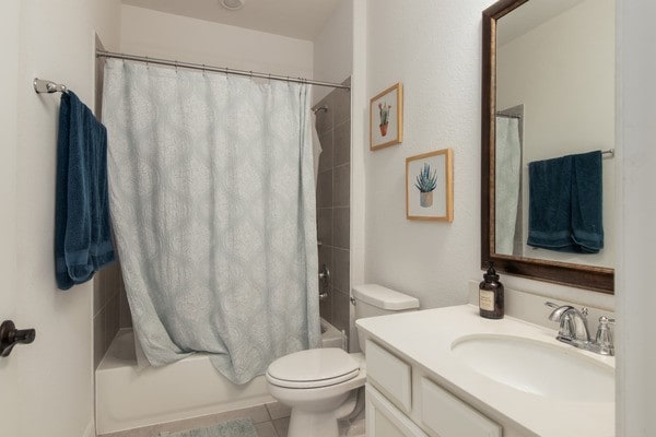 11211 Stirton, Tomball, TX 77375 - bathroom with vanity, shower / bath combination with curtain, toilet, and tile patterned floors