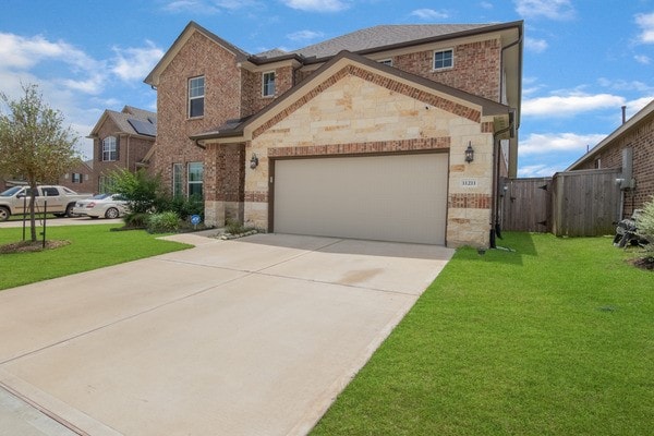 11211 Stirton, Tomball, TX 77375 - traditional home with stone siding, brick siding, a garage, and concrete driveway