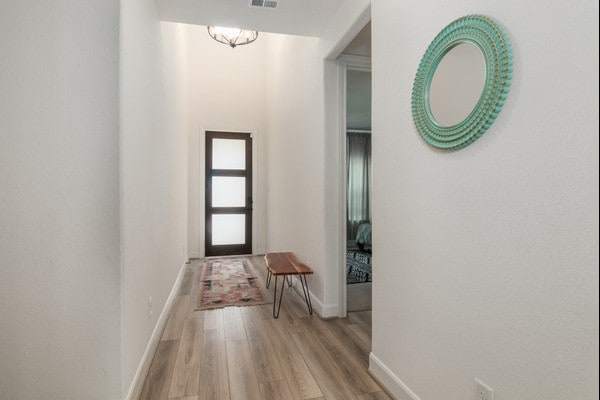 11211 Stirton, Tomball, TX 77375 - hallway featuring light wood-style flooring and baseboards