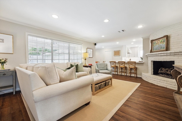 2910 Ann Arbor Dr, Houston, TX 77063 - living area featuring crown molding, dark wood-type flooring, recessed lighting, and a fireplace