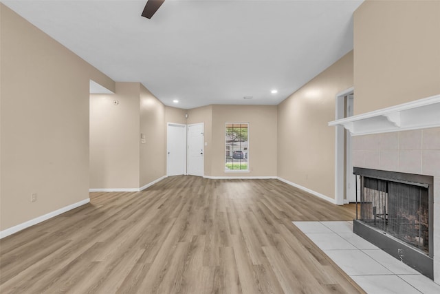 5514 Clarkston Ln, Spring, TX 77379 - unfurnished living room featuring wood finished floors, baseboards, a tiled fireplace, ceiling fan, and recessed lighting