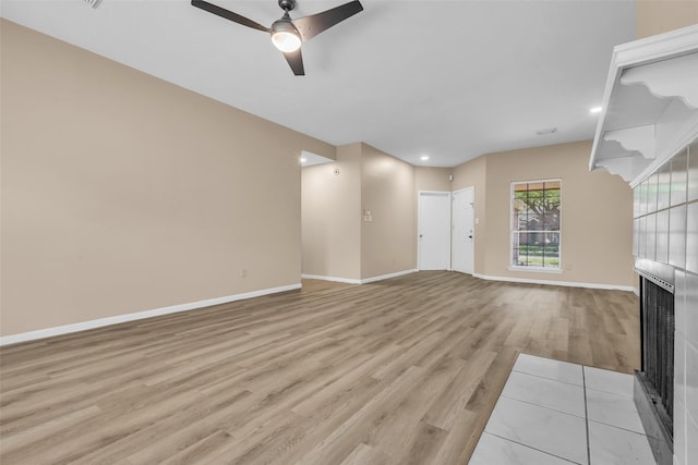 5514 Clarkston Ln, Spring, TX 77379 - unfurnished living room featuring a fireplace, light wood-style floors, a ceiling fan, baseboards, and recessed lighting