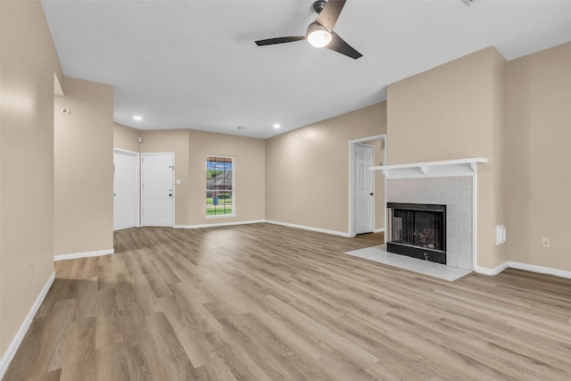 5514 Clarkston Ln, Spring, TX 77379 - unfurnished living room featuring wood finished floors, a ceiling fan, a fireplace, baseboards, and recessed lighting