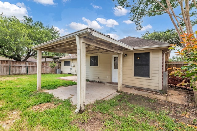 5514 Clarkston Ln, Spring, TX 77379 - rear view of house with a patio area, a shingled roof, and central air condition unit