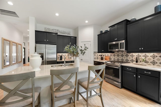 2250 Garden Arbor, Tomball, TX 77375 - kitchen with appliances with stainless steel finishes, dark cabinets, backsplash, and recessed lighting