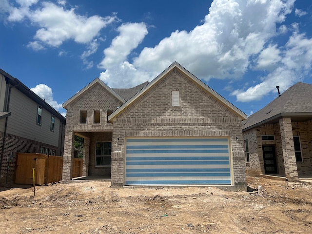 2250 Garden Arbor, Tomball, TX 77375 - view of front of house featuring brick siding, an attached garage, and driveway