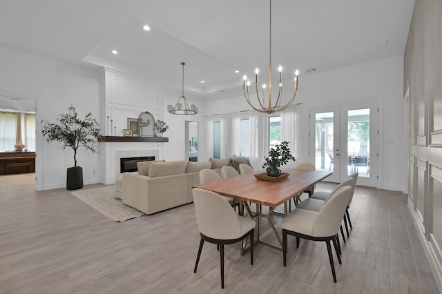 4792 W Fork Blvd, Conroe, TX 77304 - dining area with recessed lighting, french doors, a glass covered fireplace, light wood-type flooring, and a chandelier