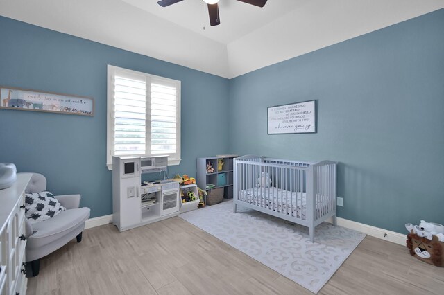 4792 W Fork Blvd, Conroe, TX 77304 - bedroom with wood finished floors, a nursery area, baseboards, and a ceiling fan