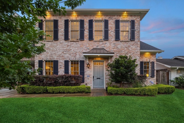6225 Piping Rock Ln, Houston, TX 77057 - colonial inspired home with a lawn and brick siding