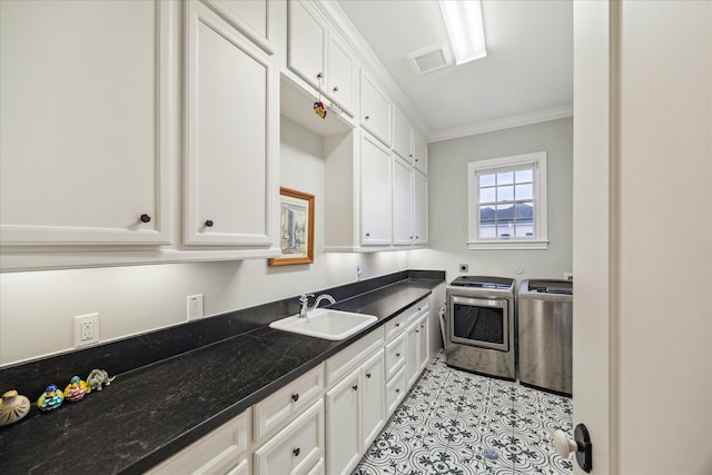 6225 Piping Rock Ln, Houston, TX 77057 - kitchen with a sink, separate washer and dryer, white cabinets, crown molding, and dark stone counters