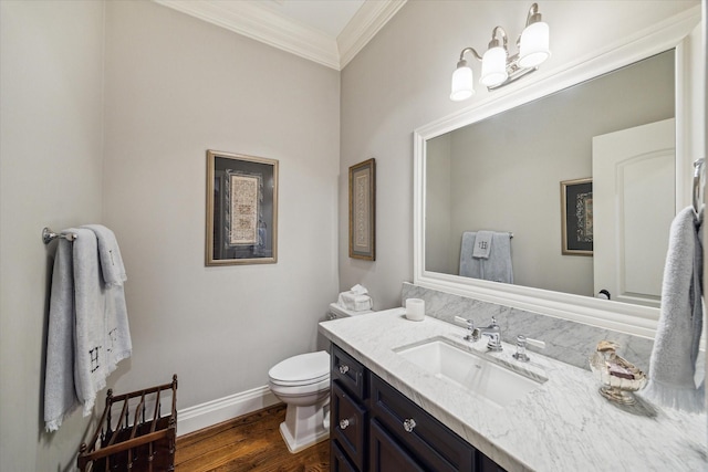 6225 Piping Rock Ln, Houston, TX 77057 - half bath with crown molding, toilet, vanity, baseboards, and wood finished floors