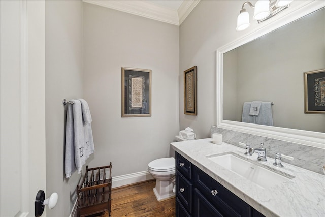 6225 Piping Rock Ln, Houston, TX 77057 - half bathroom with crown molding, toilet, vanity, baseboards, and wood finished floors