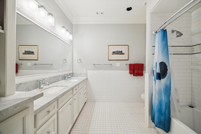 6225 Piping Rock Ln, Houston, TX 77057 - full bathroom with double vanity, ornamental molding, toilet, tile walls, and shower / bath combo
