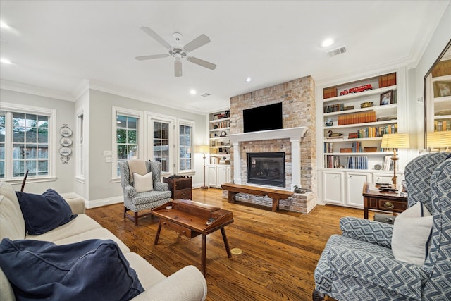 6225 Piping Rock Ln, Houston, TX 77057 - living room with ceiling fan, crown molding, wood finished floors, a fireplace, and built in shelves