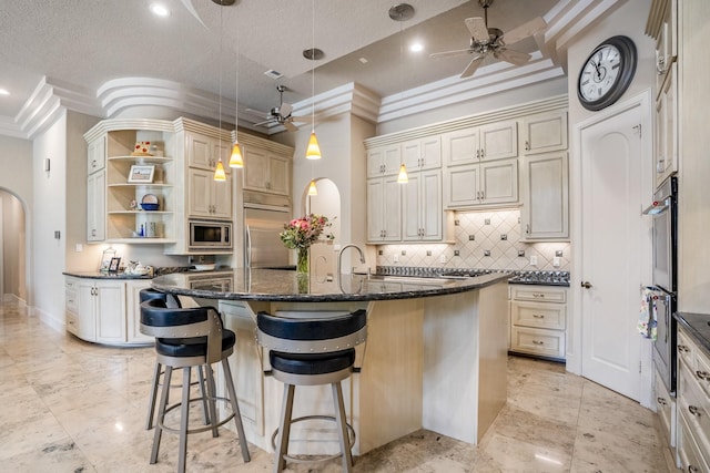 11 Bracebridge Dr, The Woodlands, TX 77382 - kitchen with a ceiling fan, arched walkways, built in appliances, open shelves, and crown molding
