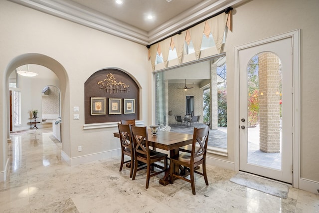11 Bracebridge Dr, The Woodlands, TX 77382 - dining room featuring arched walkways, baseboards, a high ceiling, and marble finish flooring
