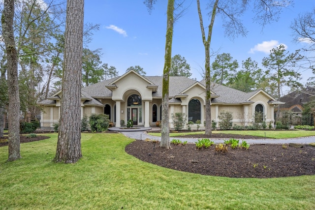 11 Bracebridge Dr, The Woodlands, TX 77382 - view of front of property with a front yard, roof with shingles, and stucco siding