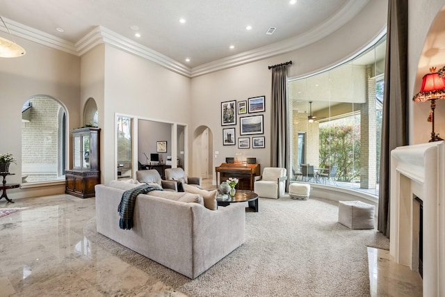 11 Bracebridge Dr, The Woodlands, TX 77382 - living area featuring arched walkways, ornamental molding, a towering ceiling, recessed lighting, and a high end fireplace