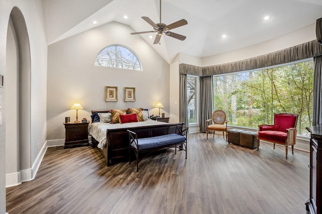 11 Bracebridge Dr, The Woodlands, TX 77382 - bedroom with wood finished floors, recessed lighting, high vaulted ceiling, arched walkways, and baseboards