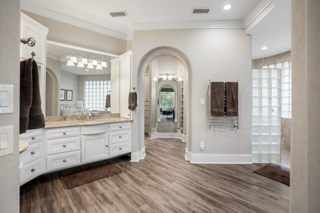 11 Bracebridge Dr, The Woodlands, TX 77382 - full bathroom featuring ornamental molding, wood finished floors, vanity, walk in shower, and baseboards