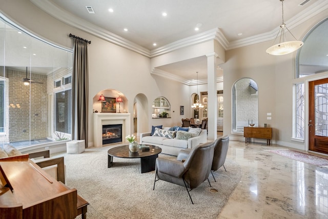 11 Bracebridge Dr, The Woodlands, TX 77382 - living area with a glass covered fireplace, crown molding, recessed lighting, marble tiled flooring, and a chandelier