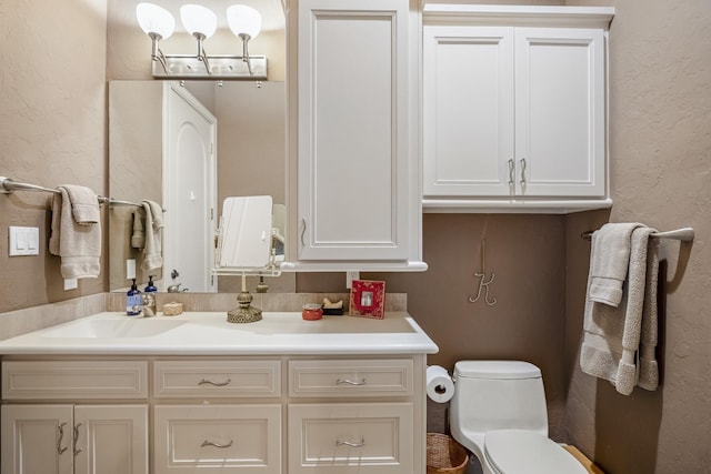 11 Bracebridge Dr, The Woodlands, TX 77382 - bathroom with toilet, vanity, and a textured wall