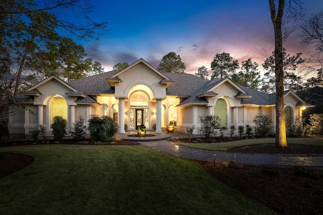 11 Bracebridge Dr, The Woodlands, TX 77382 - view of front of house featuring a front yard, roof with shingles, and brick siding