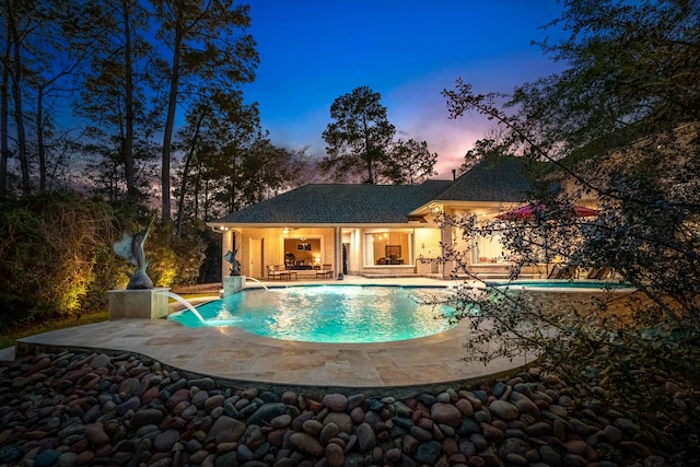 11 Bracebridge Dr, The Woodlands, TX 77382 - pool at dusk featuring a patio and an outdoor pool