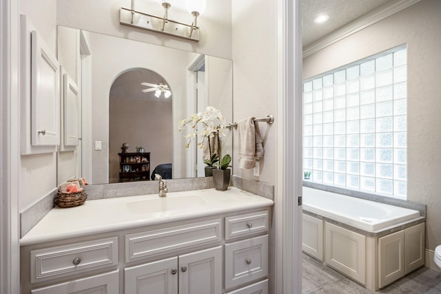 11 Bracebridge Dr, The Woodlands, TX 77382 - ensuite bathroom with vanity, a garden tub, toilet, ornamental molding, and a ceiling fan