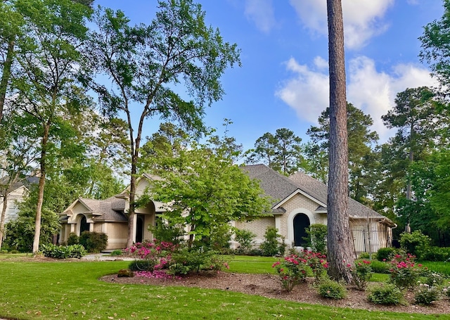11 Bracebridge Dr, The Woodlands, TX 77382 - obstructed view of property with a front lawn and roof with shingles