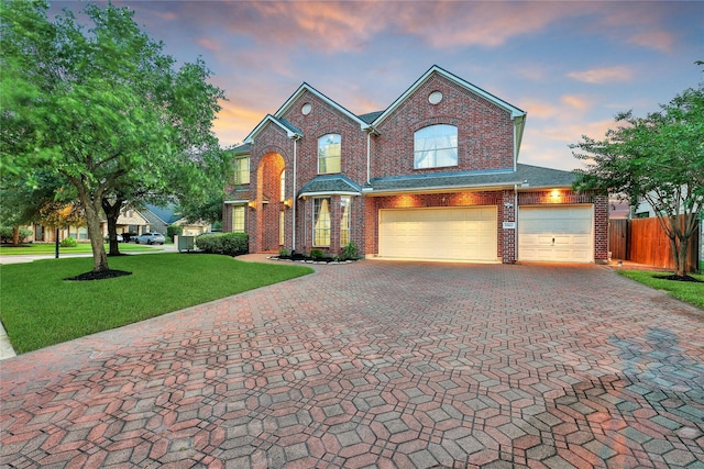 17862 Camp Cove Dr, Cypress, TX 77429 - traditional-style house with brick siding, decorative driveway, and a garage