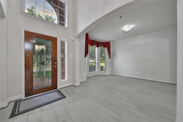 17862 Camp Cove Dr, Cypress, TX 77429 - foyer featuring arched walkways, baseboards, and wood finished floors