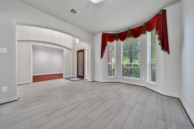 17862 Camp Cove Dr, Cypress, TX 77429 - spare room featuring arched walkways, wood finished floors, and baseboards