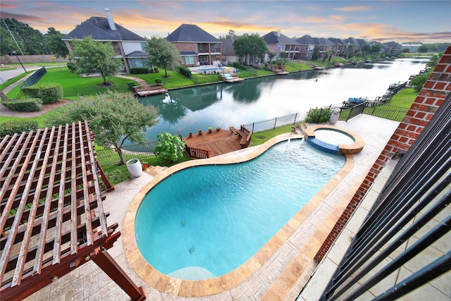 17862 Camp Cove Dr, Cypress, TX 77429 - pool at dusk with a water view, a pool with connected hot tub, and a residential view