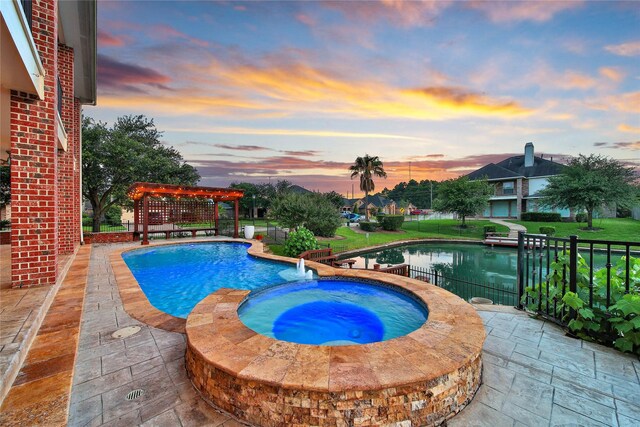 17862 Camp Cove Dr, Cypress, TX 77429 - view of swimming pool with a pergola, a pool with connected hot tub, and a yard