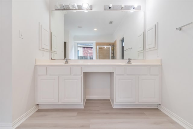 14339 Tasmania Ct, Sugar Land, TX 77498 - full bath with double vanity, a shower stall, ornamental molding, wood finished floors, and baseboards