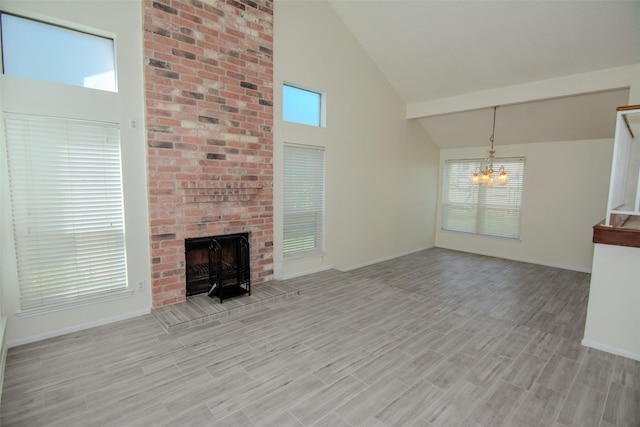 17647 Seven Pines Dr, Spring, TX 77379 - unfurnished living room with high vaulted ceiling, a chandelier, a fireplace, light wood-type flooring, and baseboards