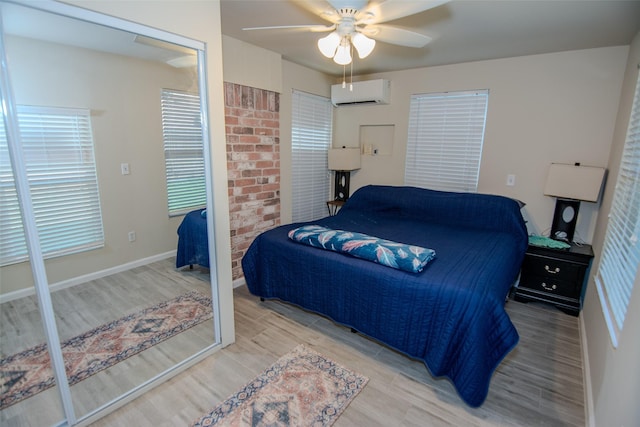 17647 Seven Pines Dr, Spring, TX 77379 - bedroom with an AC wall unit, wood finished floors, and ceiling fan