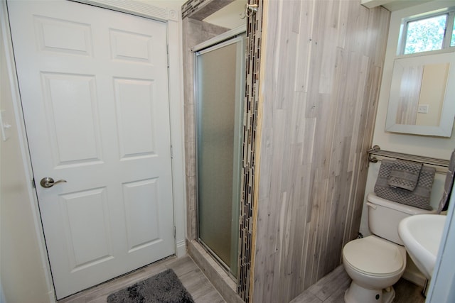 17647 Seven Pines Dr, Spring, TX 77379 - full bathroom with a shower stall, toilet, wood finished floors, and a sink
