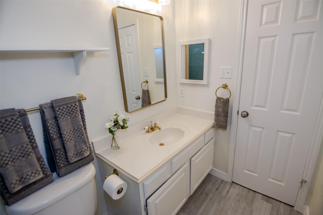 17647 Seven Pines Dr, Spring, TX 77379 - half bathroom featuring vanity, wood finished floors, and toilet
