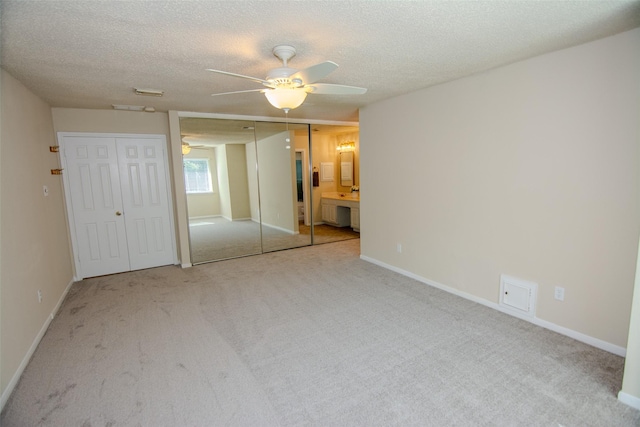 17647 Seven Pines Dr, Spring, TX 77379 - unfurnished bedroom with two closets, carpet flooring, a textured ceiling, a ceiling fan, and ensuite bathroom